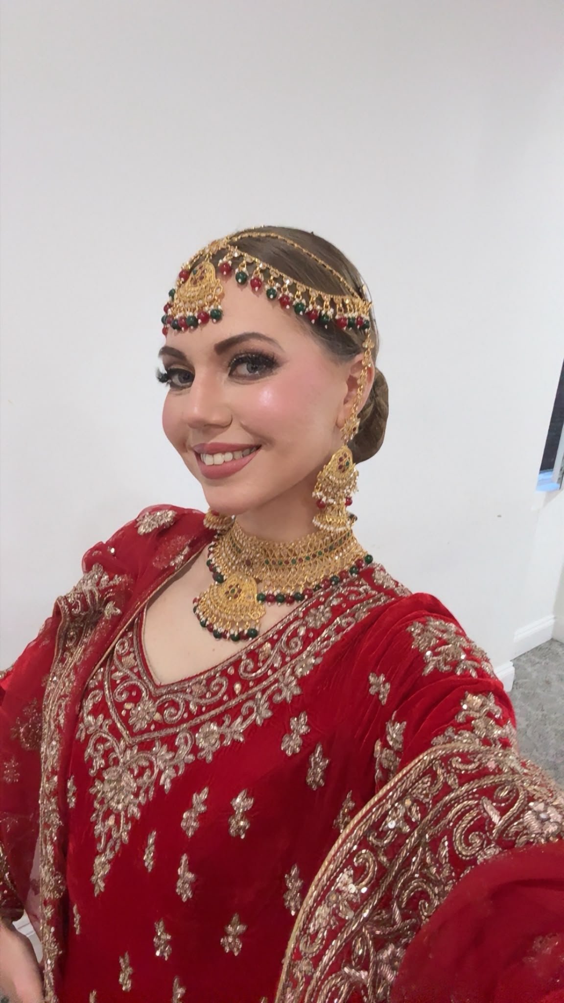 Bridal red gold outfit tikka portrait