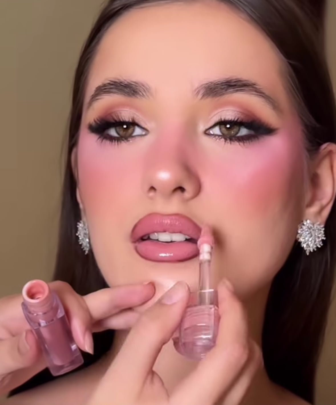 Lip gloss application closeup