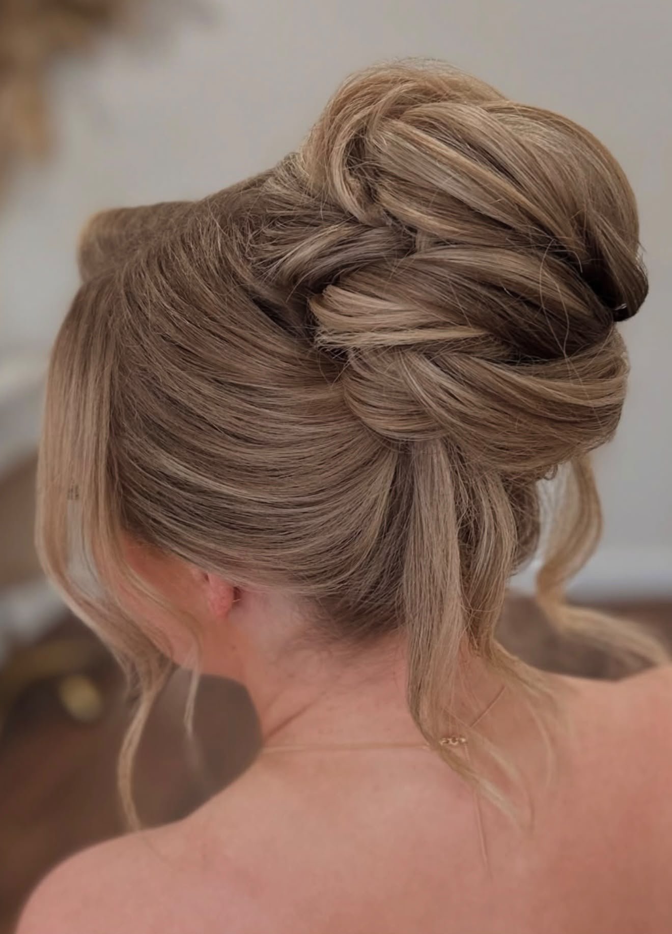 Textured high bun updo back view